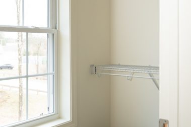 Bedroom 1 Walk-In Closet of a 3 Bedroom Unit in the Evergreen Way Community, a high-end townhouse community by Socha Companies in Manchester NH